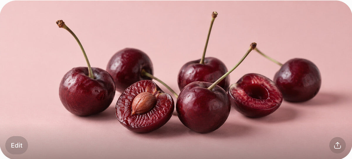 Fresh sour cherries with stems on a blush-pink surface