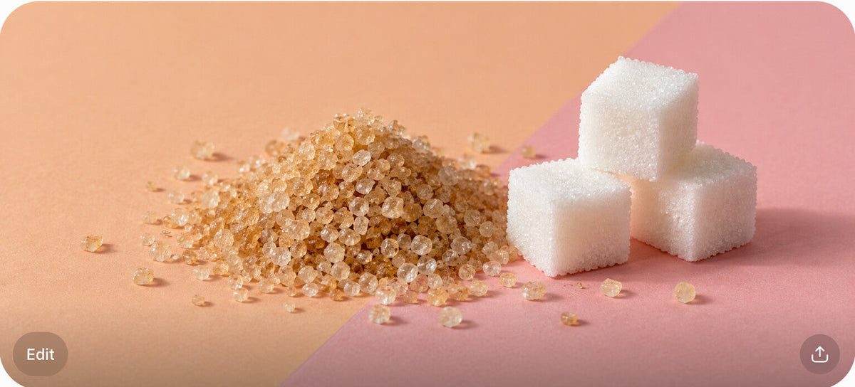 Raw cane sugar pile and sugar cubes on a split peach and blush surface