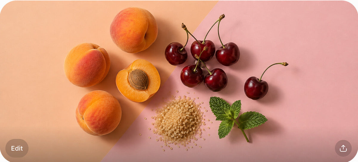 Apricots, cherries, a sugar pile, and a mint sprig on a split peach and blush surface