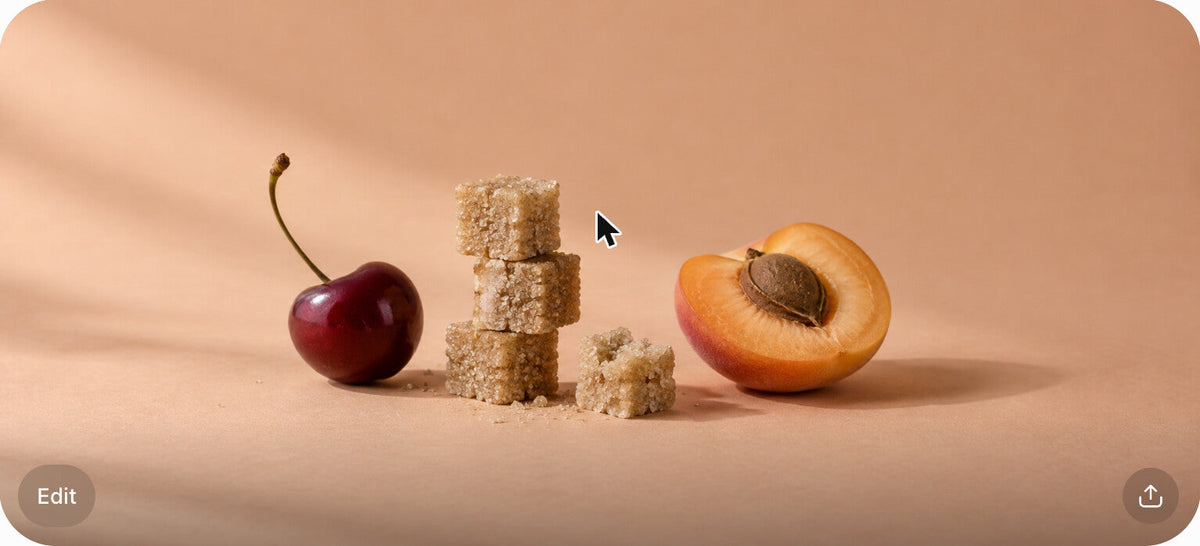 Raw cane sugar cubes next to a cherry and an apricot half on a warm peach surface