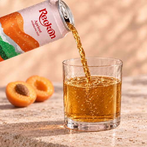 Reckon Apricot poured into a short glass with halved fresh apricots alongside