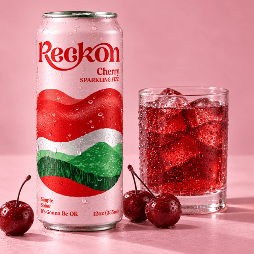 Reckon Cherry can beside a poured glass over ice with fresh cherries