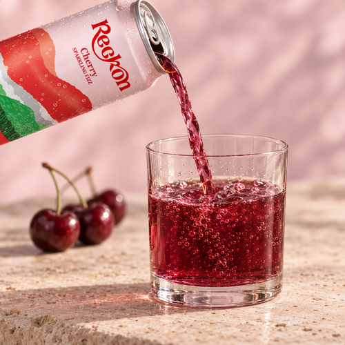 Reckon Cherry poured into a short glass with fresh cherries alongside